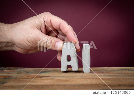 AI Word Created from Concrete Alphabet Letters on Wooden Desk AI Word Created from Concrete Alphabet Letters on Wooden Desk 125143060