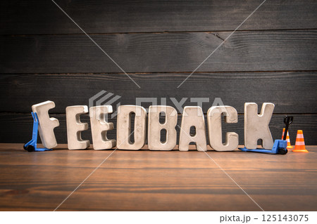 FEEDBACK Text with Traffic Cones and Forklift Toy on Desk FEEDBACK Text with Traffic Cones and Forklift Toy on Desk 125143075