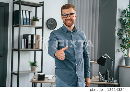 Giving hand. Man is working in the modern office. Conception of business and freelance Giving hand. Man is working in the modern office. Conception of business and freelance 125143244