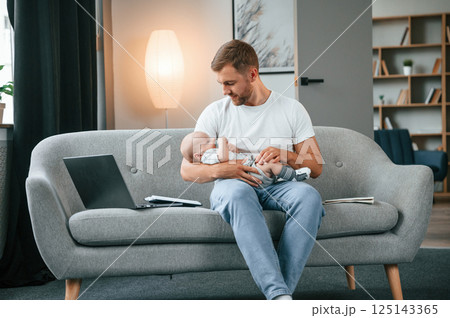 Father with toddler is at home, taking care of his son Father with toddler is at home, taking care of his son 125143365