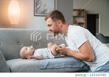 Father with toddler is at home, taking care of his son Father with toddler is at home, taking care of his son 125143394