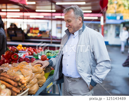 Middle aged man buying vegetables 125143489