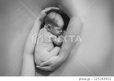 A newborn baby is wrapped in diapers with a wool cap in a basket. Swaddling, maternity hospital, family, ivf, life planning, parenting. A mother's love for her child. Baby food. High quality photo A newborn baby is wrapped in diapers with a wool cap in a basket. Swaddling, maternity hospital, family, ivf, life planning, parenting. A mother's love for her child. Baby food. High quality photo 125143911