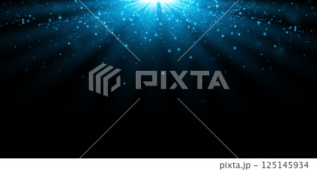 Stunning and Beautiful Blue Light Rays with Sparkles shining on a Deep Dark Background, creating a mesmerizing effect Stunning and Beautiful Blue Light Rays with Sparkles shining on a Deep Dark Background, creating a mesmerizing effect 125145934