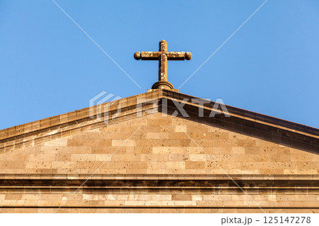 Top of a catholic church roof with cross 125147278
