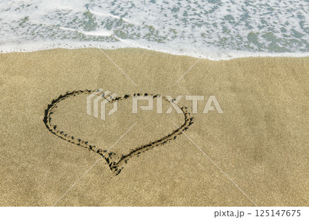 Heart shape on the sandy beach Heart shape on the sandy beach 125147675