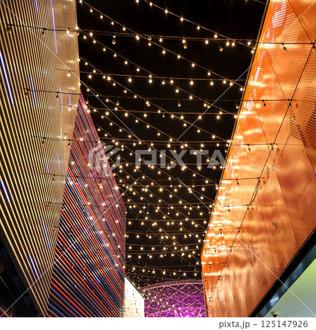 The night sky is decorated with lanterns suspended on ropes between houses 125147926