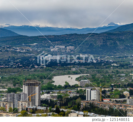 Cityscape view of Tbilisi, the capital of Georgia with snow-capped Caucasus mountains in the distance 125148031