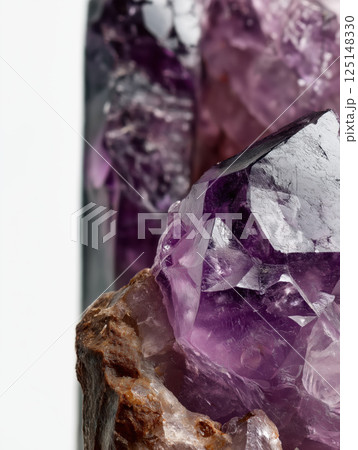 Macro shot of amethyst stone showing detailed raw texture on white background. Ultra realistic mineral photography. Studio close up. Geology and gemology concept. Design for poster, print, banner 125148330