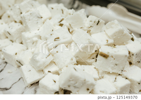 Brine goat cheese. Delicate curd cheese with spices and herbs Brine goat cheese. Delicate curd cheese with spices and herbs 125149370