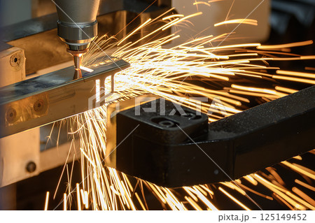Close up scene the fiber laser cutting machine cut the square shape stainless steel tube with sparkling light. Close up scene the fiber laser cutting machine cut the square shape stainless steel tube with sparkling light. 125149452