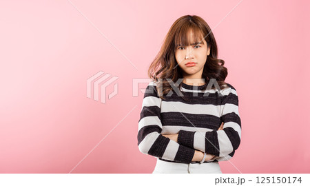 Asian happy portrait beautiful cute young woman standing angry and mad raising fist frustrated and furious while shouting with anger isolated, studio shot on pink background and copy space Asian happy portrait beautiful cute young woman standing angry and mad raising fist frustrated and furious while shouting with anger isolated, studio shot on pink background and copy space 125150174