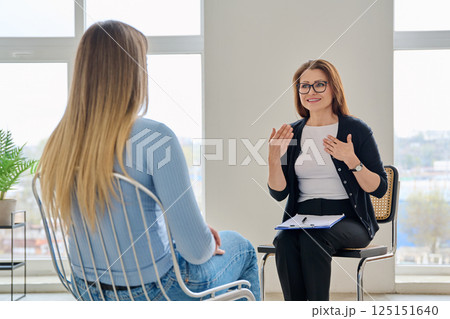 Middle aged female psychologist, therapist working with woman patient 125151640