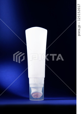 Detergent. A white bottle on a dark blue background. Mockup. Promotional photo of cosmetics. 125152017