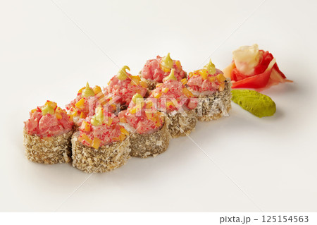 Tempura sushi rolls with spicy tuna, mango, and tobiko, featuring wasabi and ginger Tempura sushi rolls with spicy tuna, mango, and tobiko, featuring wasabi and ginger 125154563