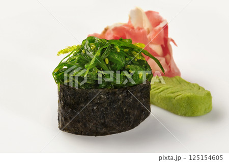 Gunkan maki sushi with chukka seaweed, pickled ginger and wasabi on white background 125154605