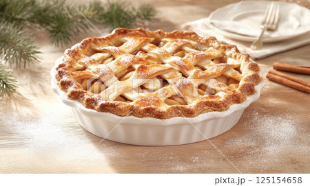 Freshly baked apple tart with cinnamon, walnuts, and golden crust. Styled in soft natural light on a rustic wooden table. Ideal for seasonal baking and holiday visuals. 125154658
