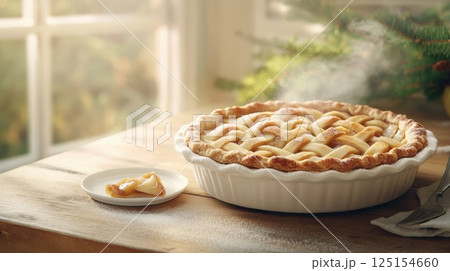 Top-down view of homemade apple pie with spiced filling and flaky crust. Warm tones, cozy textures, and vintage kitchen elements enhance the comforting mood of this dessert shot. 125154660
