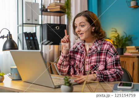 Business woman raises finger feels excited with good idea inspiration motivation using laptop 125154759