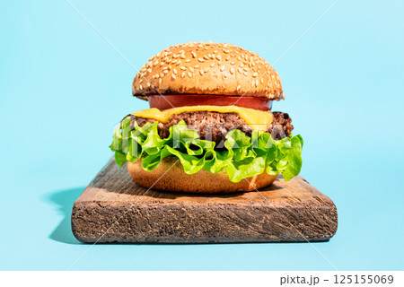 Beef burger, cheeseburger on blue background, 125155069