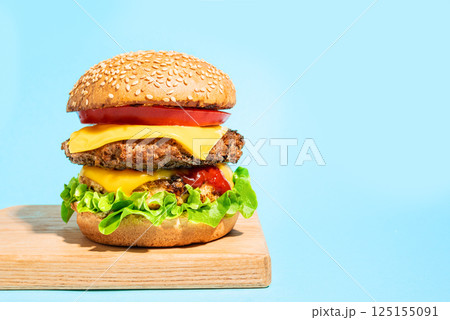 Double cheeseburger on blue background 125155091
