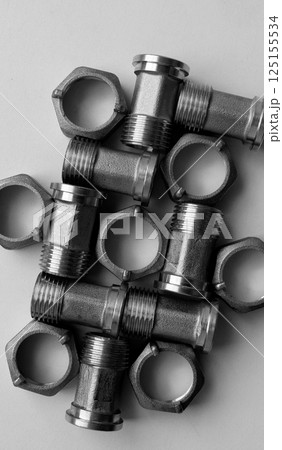 Water Plumbing Items. Water Meter Iron Fittings With Plumbing Nuts Laid Out Fitted Each Other Detailed View Water Plumbing Items. Water Meter Iron Fittings With Plumbing Nuts Laid Out Fitted Each Other Detailed View 125155534