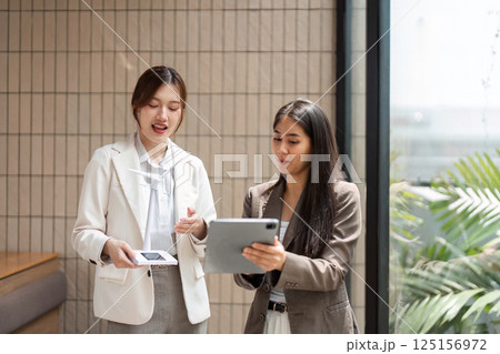 Sustainable Solutions and Networking. Two professionals engaging in a discussion to promote sustainability initiatives. Sustainable Solutions and Networking. Two professionals engaging in a discussion to promote sustainability initiatives. 125156972