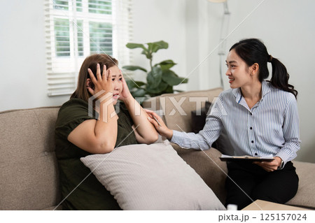 Emotional Release and Therapeutic Reflection. A psychiatrist supports her client through a moment of emotional distress in a safe counseling environment. Emotional Release and Therapeutic Reflection. A psychiatrist supports her client through a moment of emotional distress in a safe counseling environment. 125157024