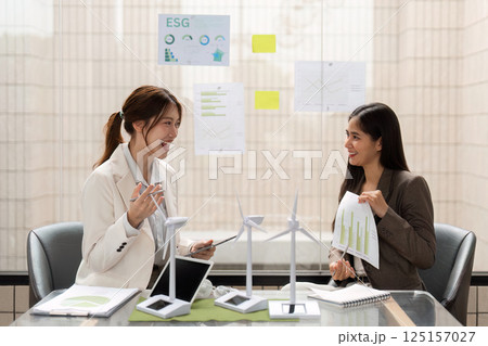 Sustainable Business Practices. Colleagues exchanging ideas on ESG initiatives for impactful solutions. 125157027
