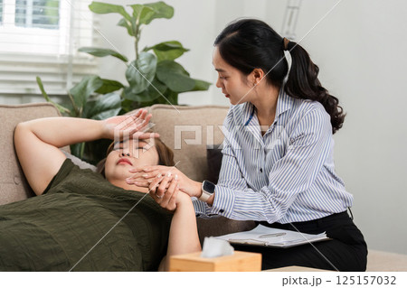 Compassion and Understanding. A therapist comforts her patient suffering from emotional distress. 125157032