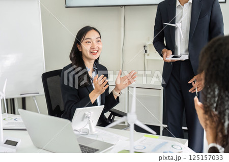 Exciting Brainstorming Session on ESG. A female team member expressing enthusiasm while discussing sustainable initiatives. 125157033