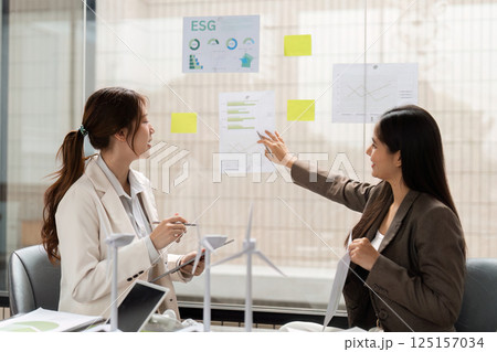 Environmental Strategy Planning. Professionals discussing ESG insights and sustainable initiatives in a collaborative environment. 125157034