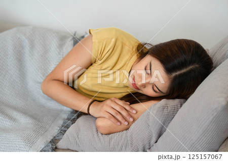 Morning Routine and Relaxation. A woman enjoying a peaceful sleep on her soft bed, embracing tranquility. Morning Routine and Relaxation. A woman enjoying a peaceful sleep on her soft bed, embracing tranquility. 125157067