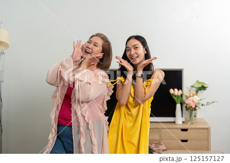 Joy and Style. Two friends capture a fun moment while showcasing stylish outfits, embodying happiness and connection. 125157127