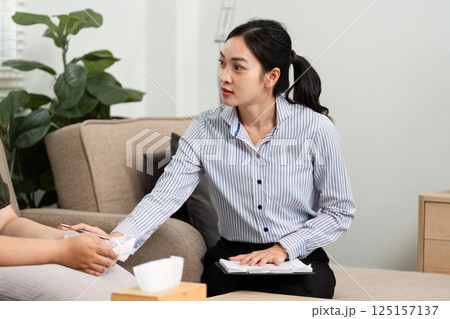 Psychiatric Consultation and Support. A psychiatrist engaging in a compassionate discussion with a client in a comfortable setting. Psychiatric Consultation and Support. A psychiatrist engaging in a compassionate discussion with a client in a comfortable setting. 125157137