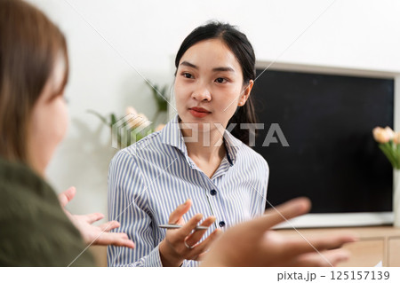 Therapeutic Conversation and Insight. A psychiatrist engaging in a meaningful dialogue with a client. Therapeutic Conversation and Insight. A psychiatrist engaging in a meaningful dialogue with a client. 125157139