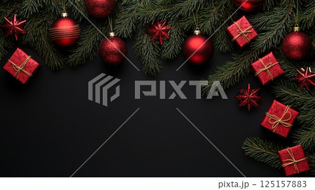 Festive christmas decorations with red ornaments and green pine branches on black background. Festive christmas decorations with red ornaments and green pine branches on black background. 125157883