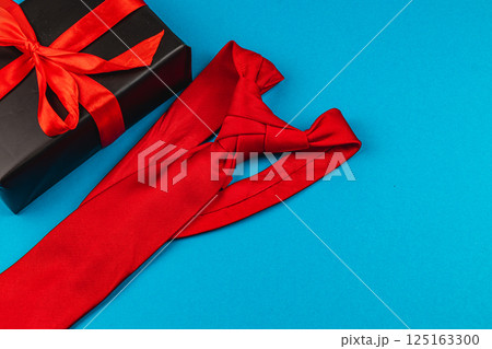 Father's day celebration with a red tie gift beside a wrapped present 125163300