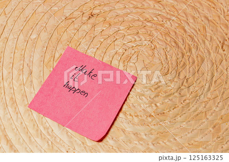 Motivational message on sticky note placed on a woven surface Motivational message on sticky note placed on a woven surface 125163325