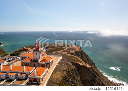Cabo da Roca Lighthouse and Monument against Cabo da Roca Lighthouse and Monument against 125163464