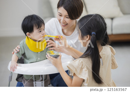 離乳食とミルクを赤ちゃんにあげる家族　　　 125163567