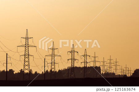 Silhouette of power transmission lines against the sunset sky Silhouette of power transmission lines against the sunset sky 125163674