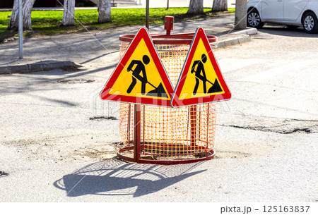 Special barriers block traffic during road repairs, pothole in the road, repairing road Special barriers block traffic during road repairs, pothole in the road, repairing road 125163837