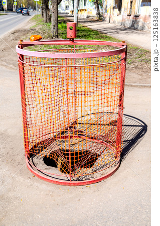 Special barriers block traffic during road repairs, pothole in the road, repairing road 125163838