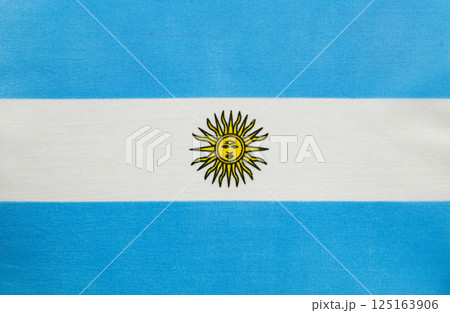 Flag of Argentina with sun emblem displayed on fabric Flag of Argentina with sun emblem displayed on fabric 125163906