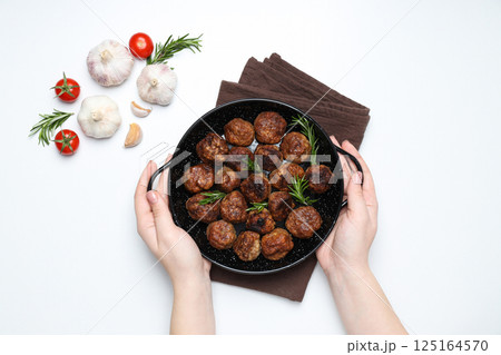 Meatballs in black bowls with spices on a white background 125164570
