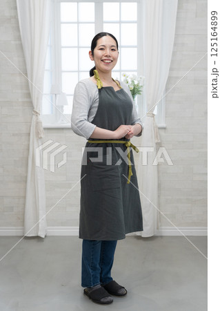 エプロンを着た笑顔の女性 125164899