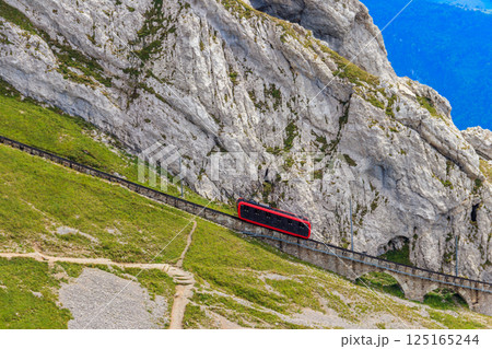Cogwheel train climbing to the top of Mount Pilatus in Canton Lucerne, Switzerland. World's steepest cogwheel railway Cogwheel train climbing to the top of Mount Pilatus in Canton Lucerne, Switzerland. World's steepest cogwheel railway 125165244