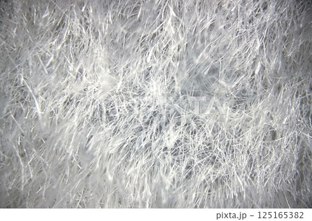 Detailed Microscopic View of Fabric Under a Microscope.Close-up view of fabric fibers under a microscope, revealing intricate texture and structural complexity. 125165382