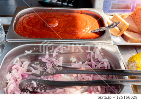 Tomato Sauce and Pickled Onions in Metal Trays 125166029